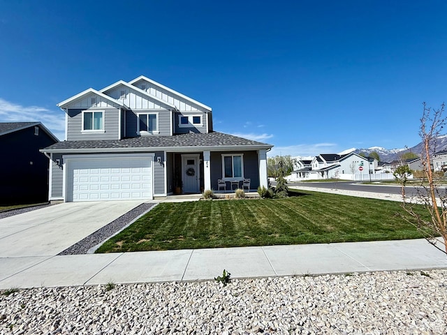view of front of home with driveway, a front lawn, a garage, a shingled roof, and covered porch