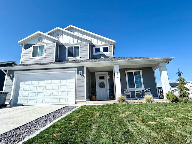 traditional-style home with a front yard, a porch, a garage, board and batten siding, and driveway
