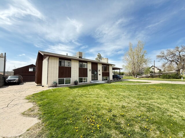 24 S 400 W, Kaysville, UT 84037 - view of front of house featuring brick siding and a front lawn