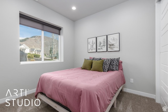 carpeted bedroom featuring baseboards and recessed lighting
