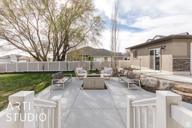 view of patio / terrace with an outdoor living space with a fire pit and a fenced backyard