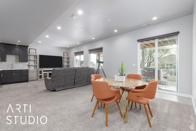 dining room with light colored carpet, visible vents, and recessed lighting