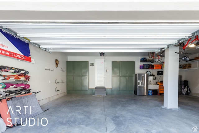 garage with stainless steel fridge