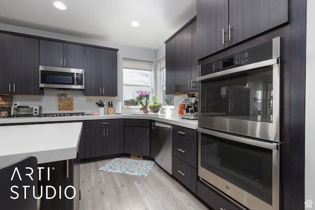 kitchen with recessed lighting, light wood-style flooring, and appliances with stainless steel finishes