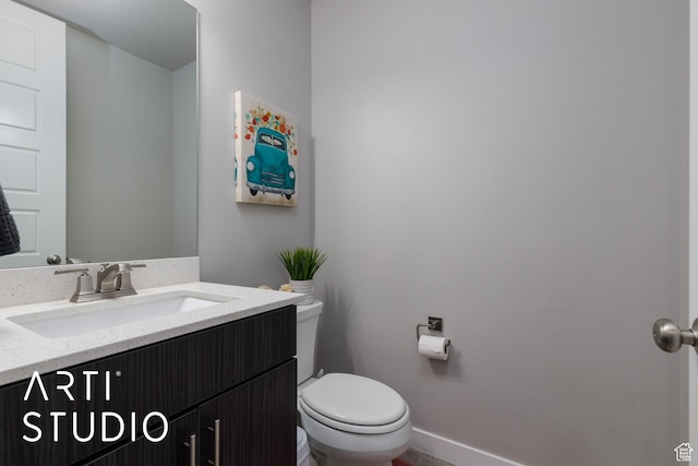 half bathroom featuring toilet and vanity
