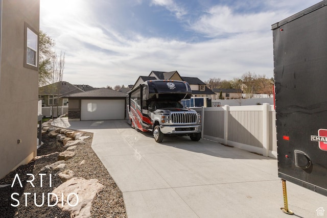exterior space featuring a garage and fence