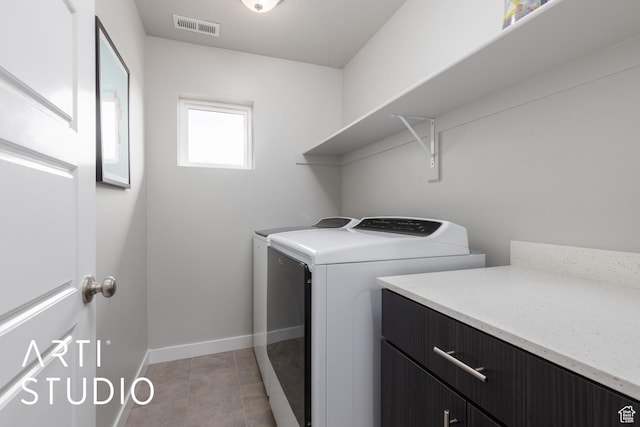 laundry area featuring baseboards, light tile patterned flooring, visible vents, washer and clothes dryer, and laundry area