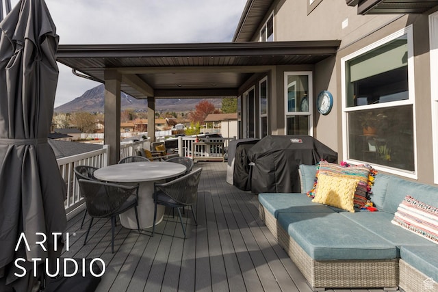 wooden terrace featuring a mountain view and area for grilling