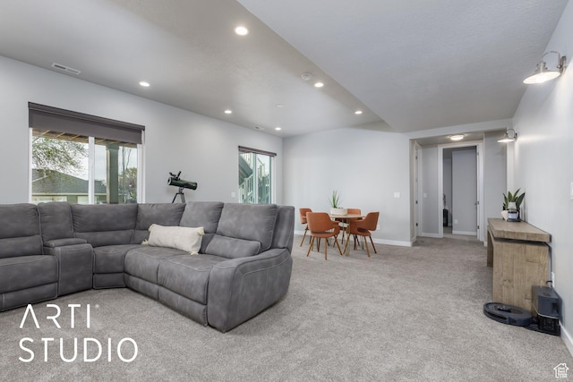 living area featuring visible vents, baseboards, recessed lighting, and carpet flooring