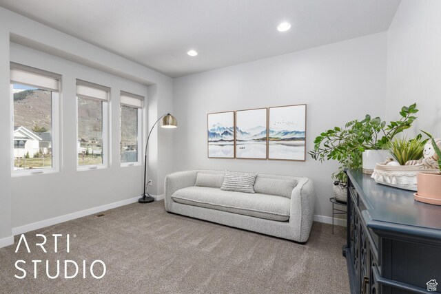 living area with recessed lighting, baseboards, and carpet floors