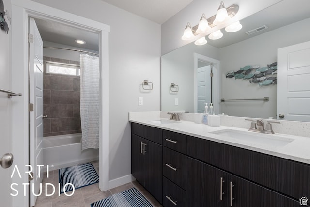 full bathroom featuring tile patterned flooring, double vanity, visible vents, and a sink