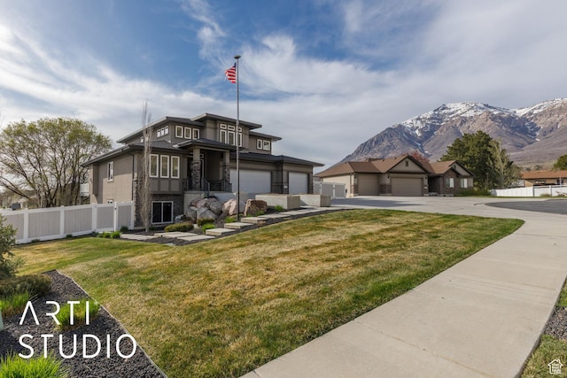 view of front of property with stone siding, a mountain view, stucco siding, and fence