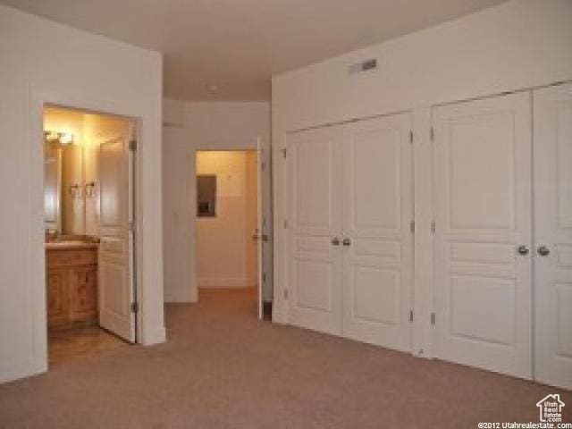 397 S State St Unit 33, Provo, UT 84606 - unfurnished bedroom with ensuite bathroom, light colored carpet, and multiple closets
