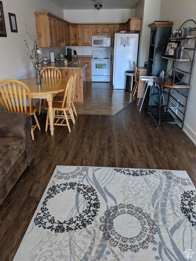 397 S State St Unit 33, Provo, UT 84606 - kitchen with baseboards, white appliances, and dark wood finished floors