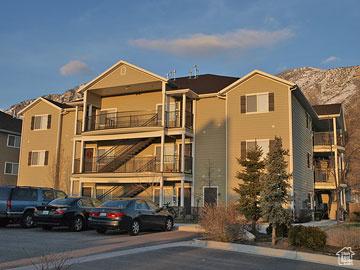 view of building exterior featuring uncovered parking and a mountain view