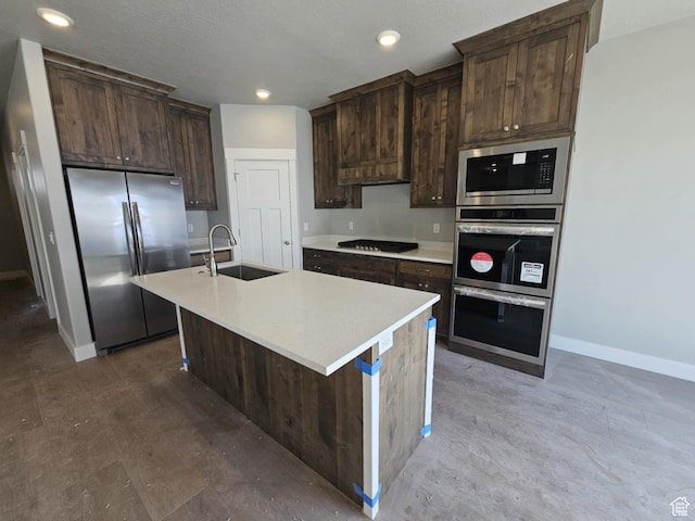 1628 S 3170 E, Spanish Fork, UT 84660 - kitchen with dark brown cabinetry, baseboards, light countertops, stainless steel appliances, and a sink
