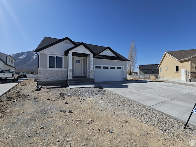 1628 S 3170 E, Spanish Fork, UT 84660 - ranch-style house with an attached garage, stone siding, and driveway