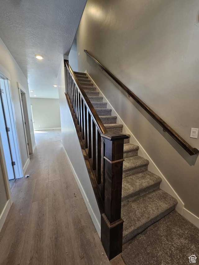 1628 S 3170 E, Spanish Fork, UT 84660 - staircase with hardwood / wood-style flooring, baseboards, and a textured ceiling