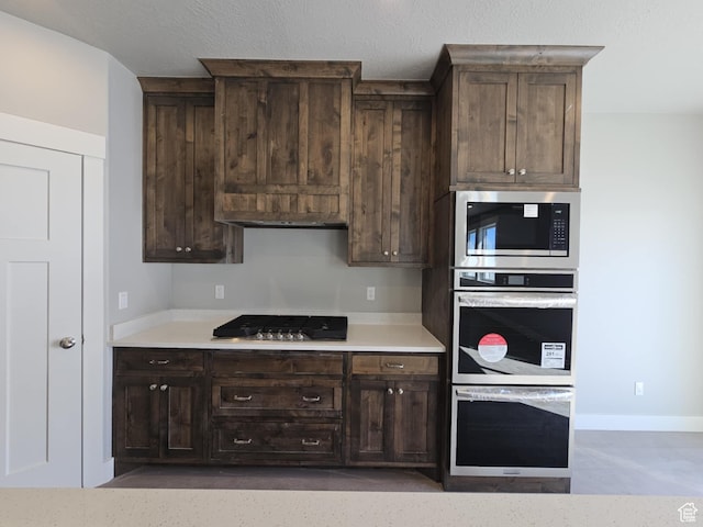 1628 S 3170 E, Spanish Fork, UT 84660 - kitchen featuring dark brown cabinetry, stainless steel gas stovetop, built in microwave, and light countertops