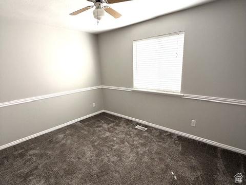 spare room featuring baseboards, ceiling fan, carpet, and visible vents