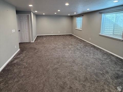 basement with carpet floors, recessed lighting, and baseboards