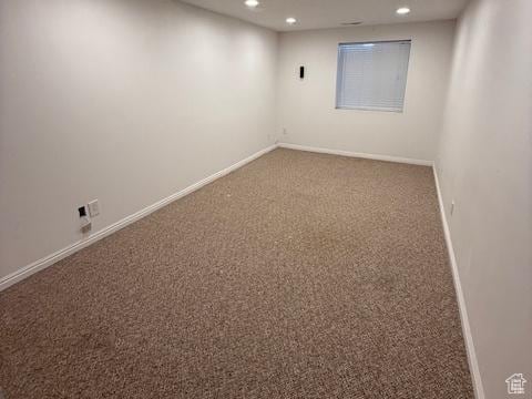 carpeted spare room featuring recessed lighting and baseboards