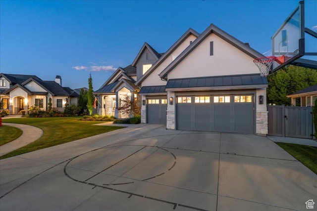 modern inspired farmhouse featuring a front yard, a standing seam roof, stone siding, metal roof, and driveway