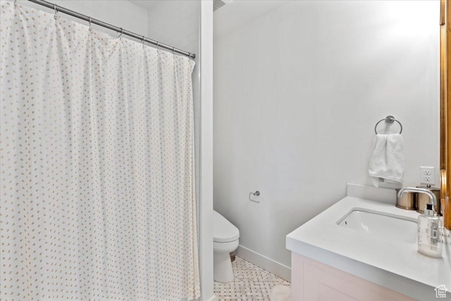 full bathroom with toilet, a shower with shower curtain, vanity, and baseboards