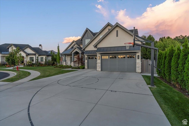 view of front of house with a standing seam roof, metal roof, stone siding, a front lawn, and driveway