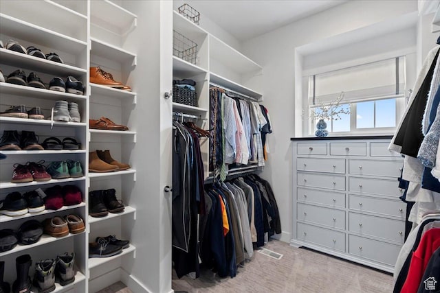 spacious closet featuring visible vents and carpet floors