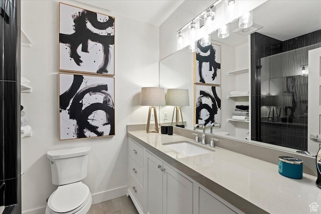 bathroom featuring an enclosed shower, vanity, baseboards, and toilet