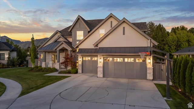 craftsman inspired home with concrete driveway, stone siding, a front yard, a standing seam roof, and metal roof