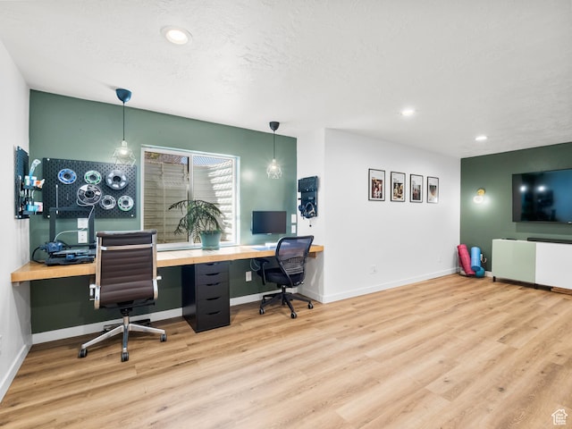 home office with recessed lighting, built in study area, baseboards, and wood finished floors