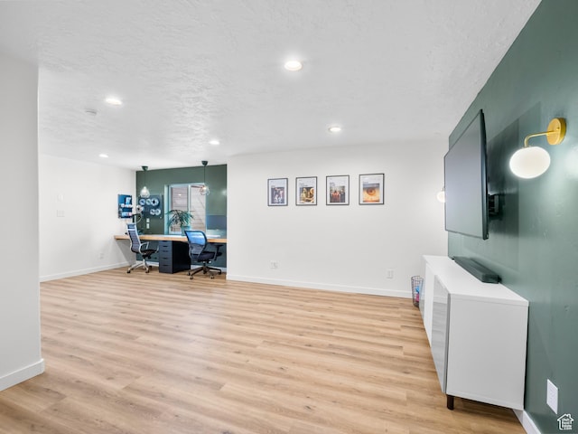 office area with baseboards, recessed lighting, light wood-style floors, and a textured ceiling