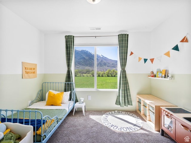 bedroom with a mountain view, carpet, and visible vents