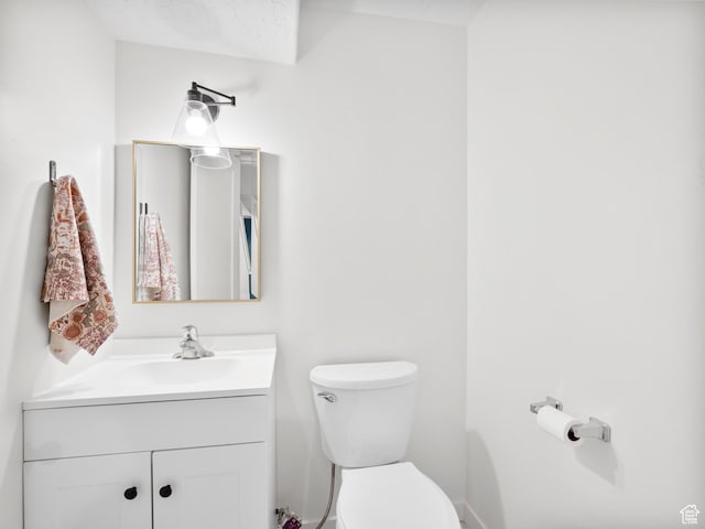 bathroom with toilet and vanity