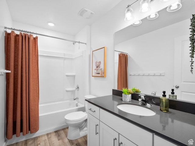 full bath with vanity, visible vents, toilet, shower / bath combo, and wood finished floors