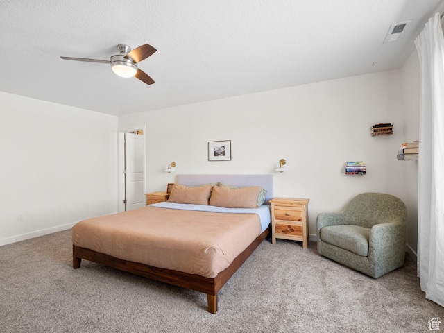 carpeted bedroom featuring visible vents, baseboards, and ceiling fan