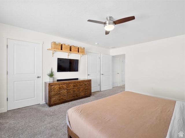 bedroom with ceiling fan, carpet flooring, and baseboards
