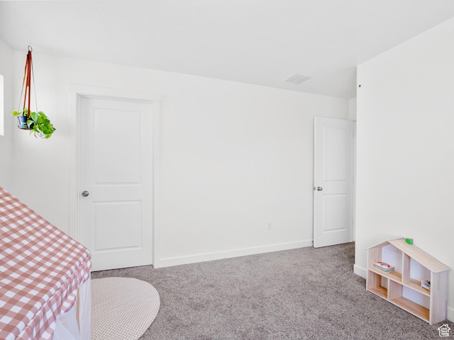 carpeted bedroom featuring visible vents and baseboards