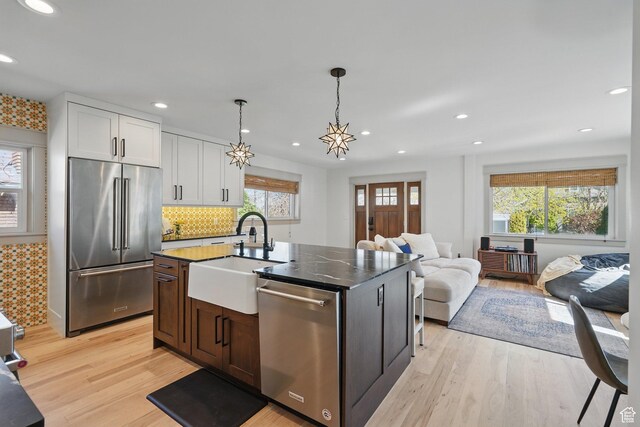 1148 E Kensington Ave, Salt Lake City, UT 84105 - kitchen featuring light wood-type flooring, recessed lighting, a sink, stainless steel appliances, and open floor plan