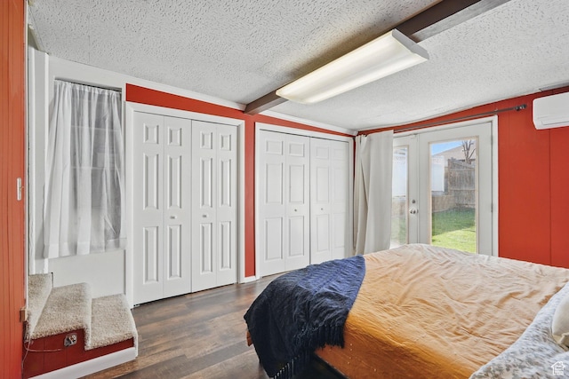1148 E Kensington Ave, Salt Lake City, UT 84105 - bedroom featuring access to outside, dark wood finished floors, a textured ceiling, a wall unit AC, and multiple closets