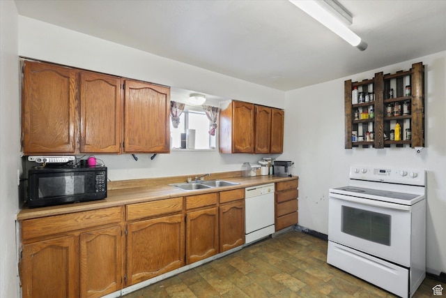 14 E Main St, Goshen, UT 84633 - kitchen featuring baseboards, white appliances, light countertops, brown cabinets, and a sink