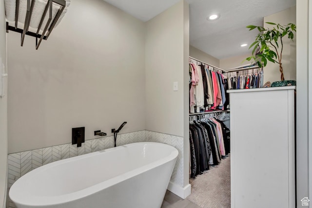 10078 S Shetland Cir S, Jordan, UT 84009 - full bath with recessed lighting, a walk in closet, a freestanding tub, and tile patterned flooring