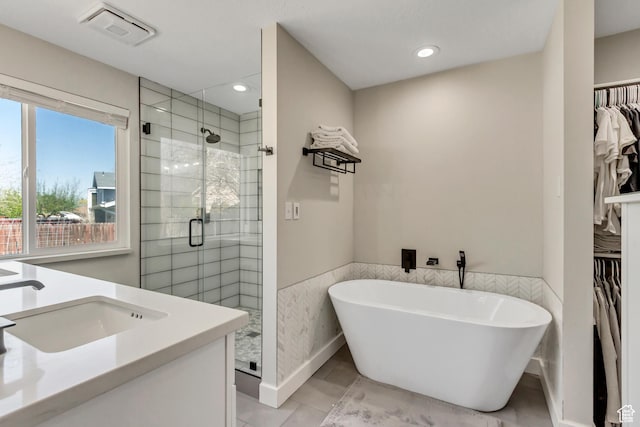 10078 S Shetland Cir S, Jordan, UT 84009 - full bathroom with a walk in closet, visible vents, a sink, and a stall shower