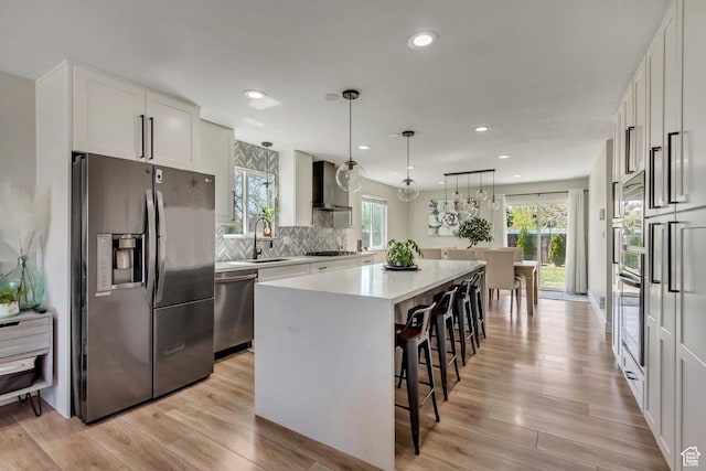 10078 S Shetland Cir S, Jordan, UT 84009 - kitchen featuring a kitchen island, a breakfast bar, light countertops, a sink, and stainless steel appliances