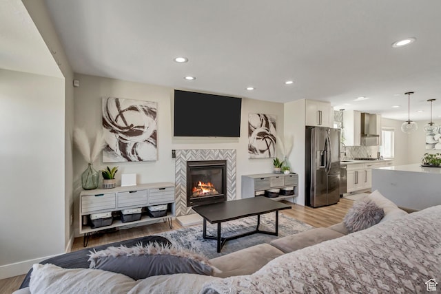 10078 S Shetland Cir S, Jordan, UT 84009 - living room featuring baseboards, light wood finished floors, recessed lighting, and a fireplace