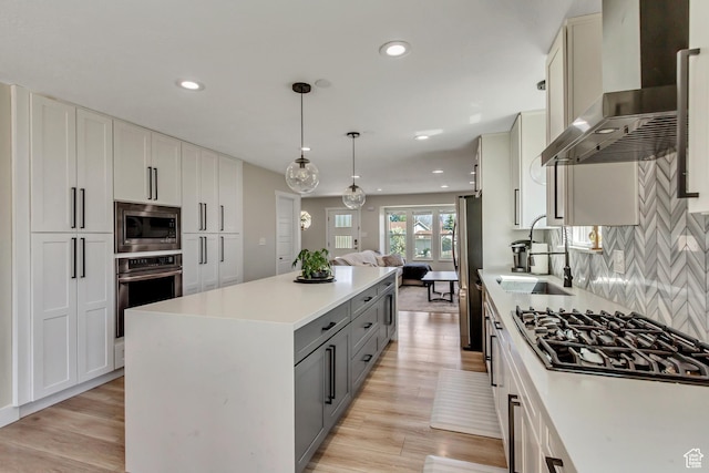 10078 S Shetland Cir S, Jordan, UT 84009 - kitchen featuring a sink, wall chimney range hood, light countertops, appliances with stainless steel finishes, and gray cabinetry