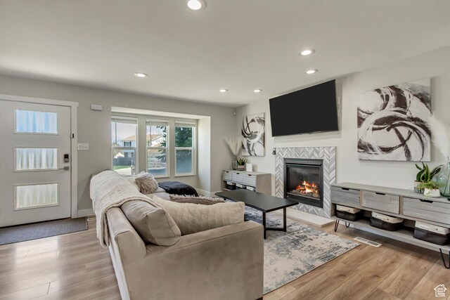 10078 S Shetland Cir S, Jordan, UT 84009 - living area with recessed lighting, a fireplace, light wood-style flooring, and baseboards