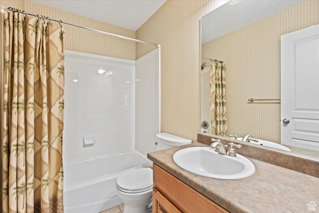 bathroom with shower / bath combo, toilet, vanity, and wallpapered walls